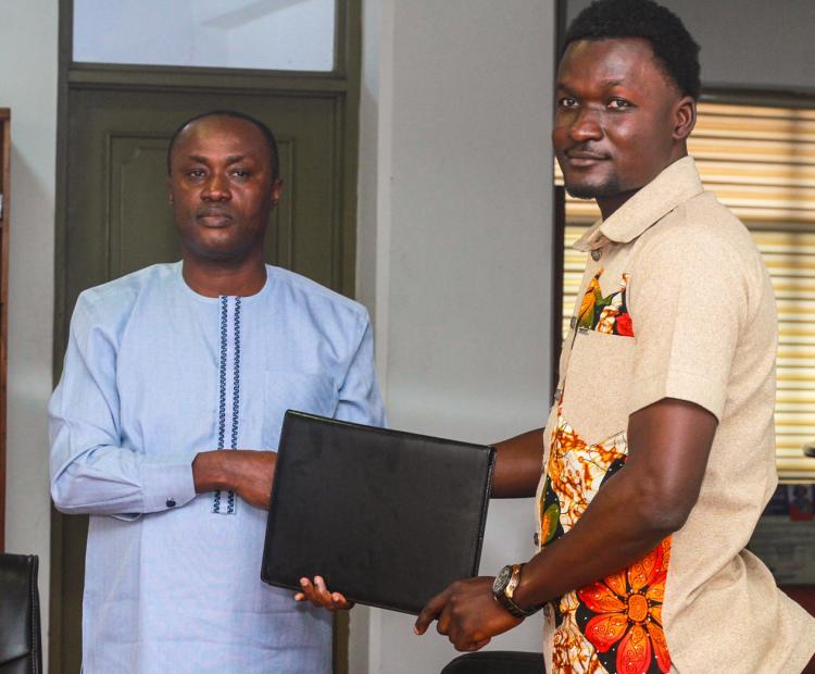 Prof. Gabriel Dwomoh (left) and Mr. Christopher Adu Gyamfi, CEO of Chafas present the signed Memorandum of Understanding (MoU) document in a group photo. 